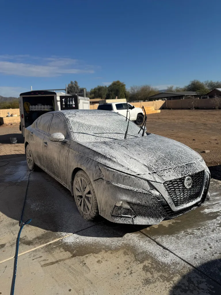 Nissan Altima covered in foam during an exterior wash