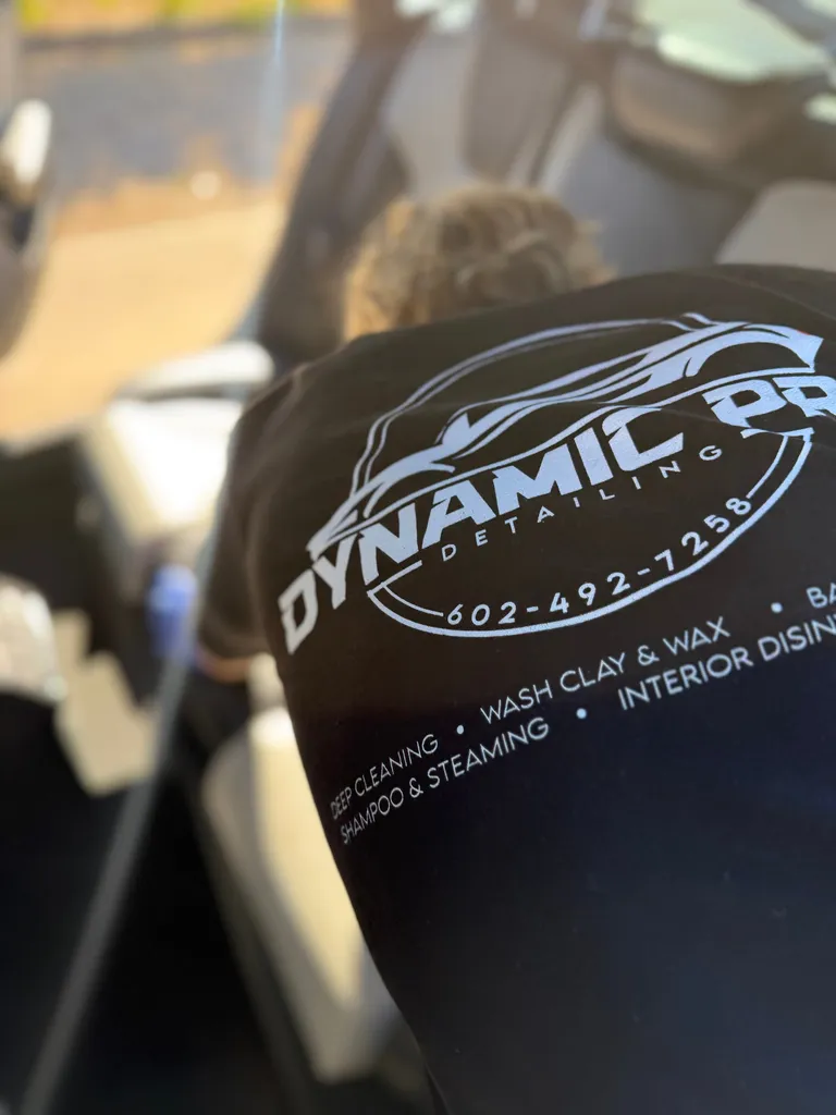Dynamic Pro Detailing team member working inside a vehicle