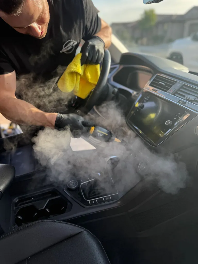 Steam cleaning a car's center console and cup holders