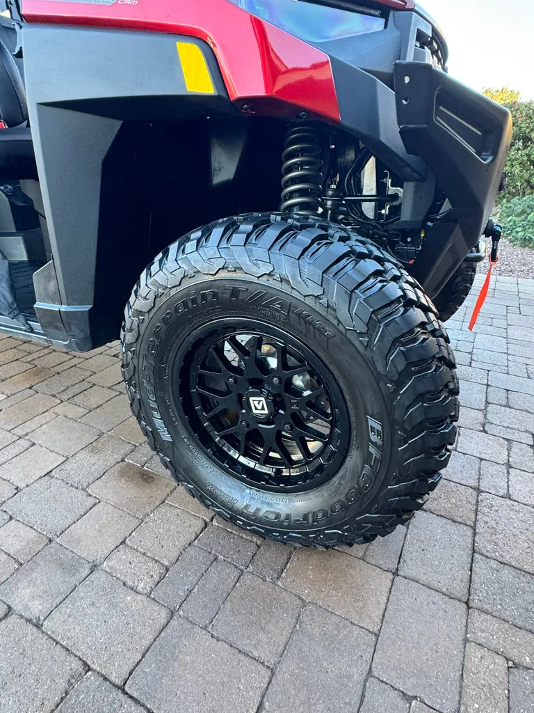 Clean off-road tire and black wheel on a side-by-side UTV